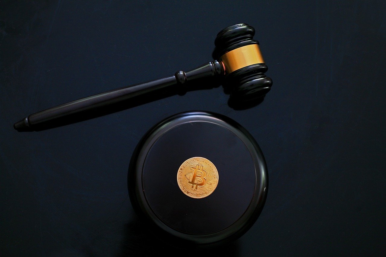 Crypto lending gavel with bitcoin on mound for decentral publishing