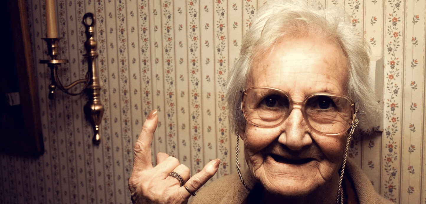 Weekly crypto news old woman signing the rock and roll sign with her hand decentral publishing