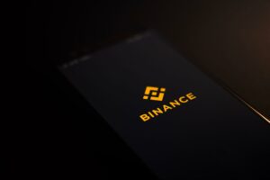 secure crypto investments smart phone with binance on the display for decentral publishing
