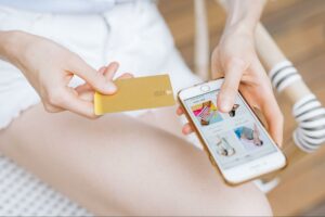 token classes woman using card purchasing on mobile phone for decentral publishing