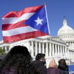 view from crowd as puerto rico flag is waved from an onlooker